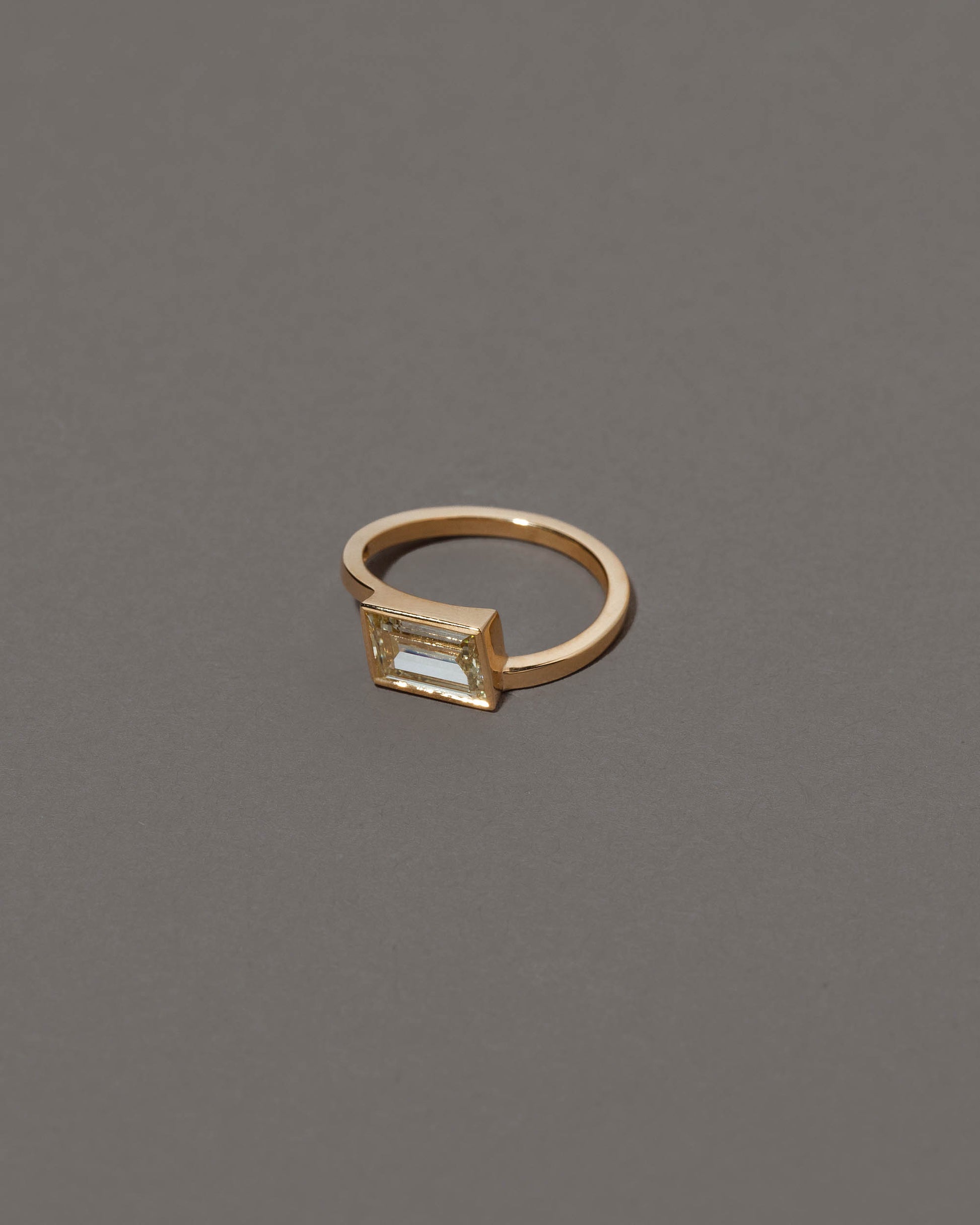 View from the side of the Jocundity Ring on grey color background.