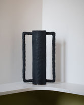 Giselle Hicks Coal Black Cylinder Vessel with Square Handle on light color background.