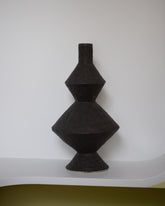 Giselle Hicks Soft Black Zig Zag Bottle on light color background.