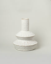 Giselle Hicks Warm White Zig Zag Bottle on light color background.