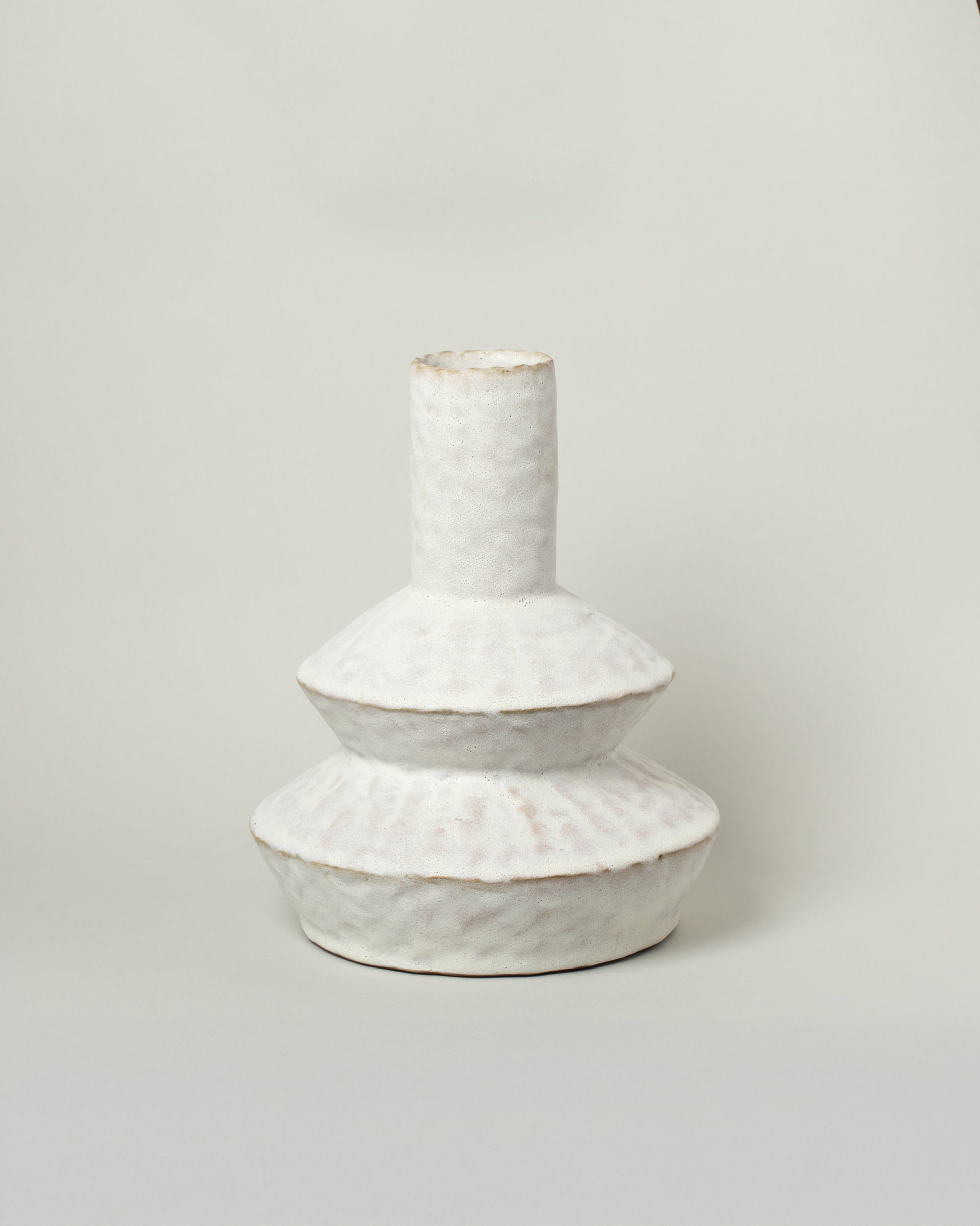 Giselle Hicks Warm White Zig Zag Bottle on light color background.