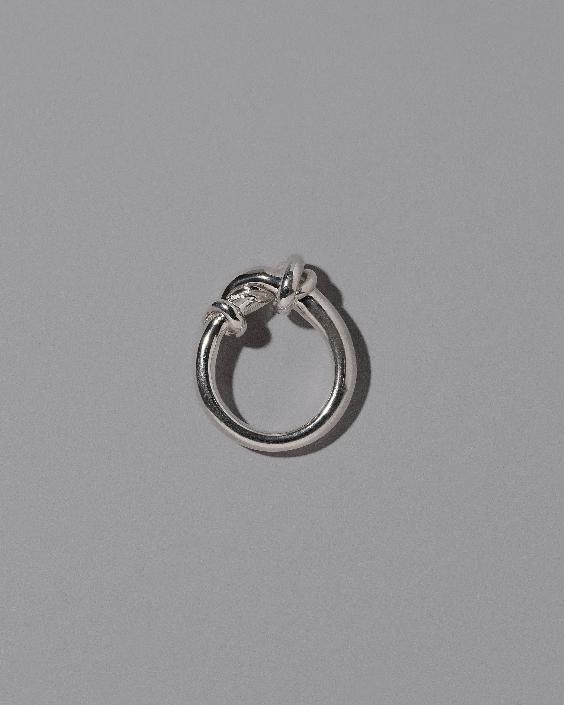 View from the side of the CRZM Sterling Silver Ridge Ring on light color background.