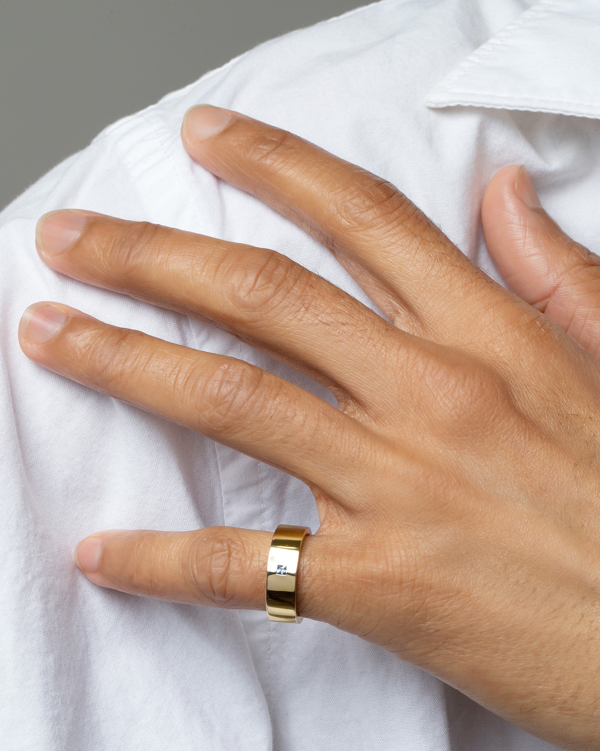 Gold Yogo Mine Cornflower Blue Sapphire 5mm Square Cut Piet Band on male model.