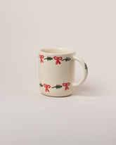 Helen Levi Lizard Holiday Mug on light color background.
