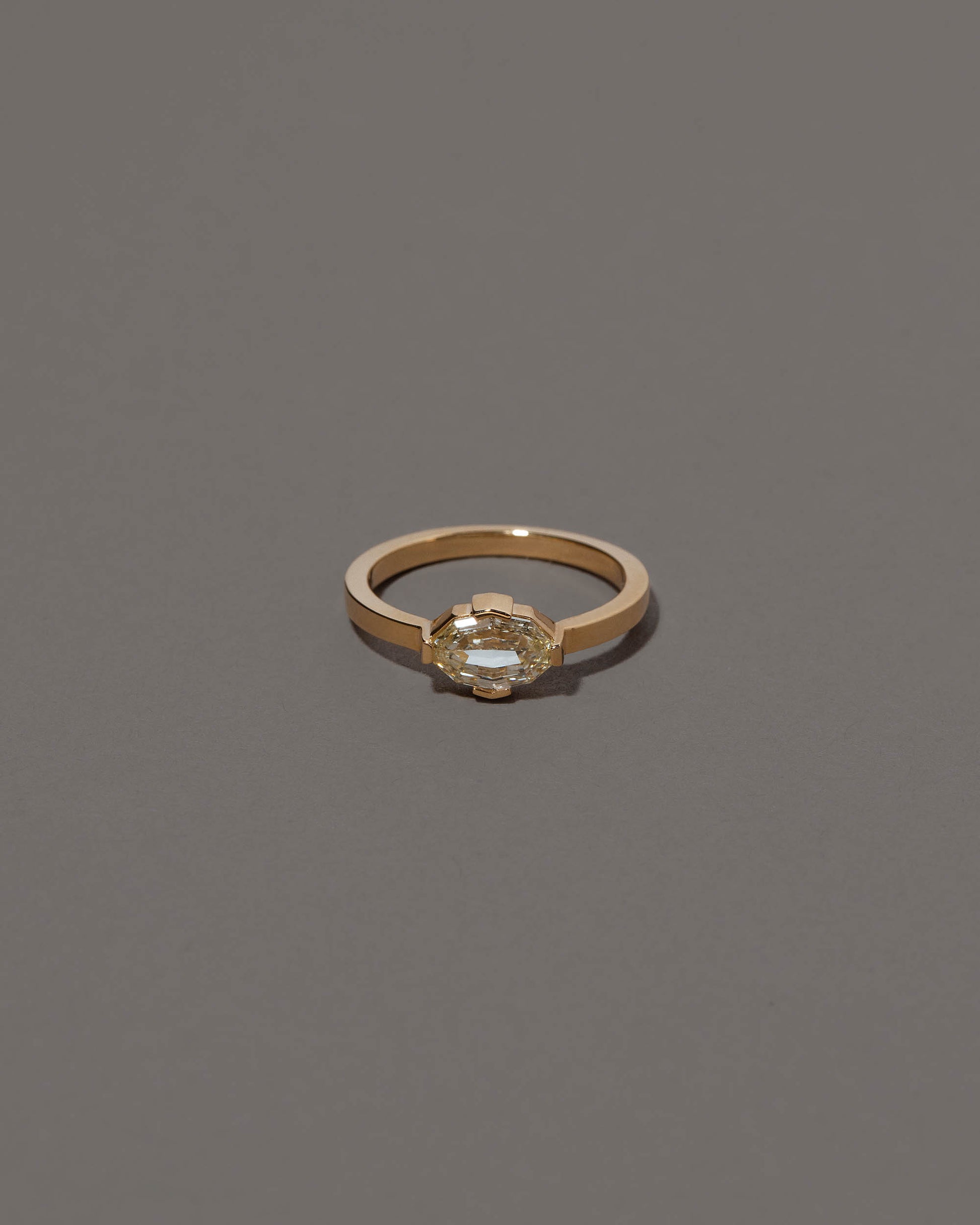Beholden Ring on grey color background.