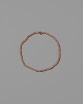 Pink Seed Pearl Anklet on light color background.