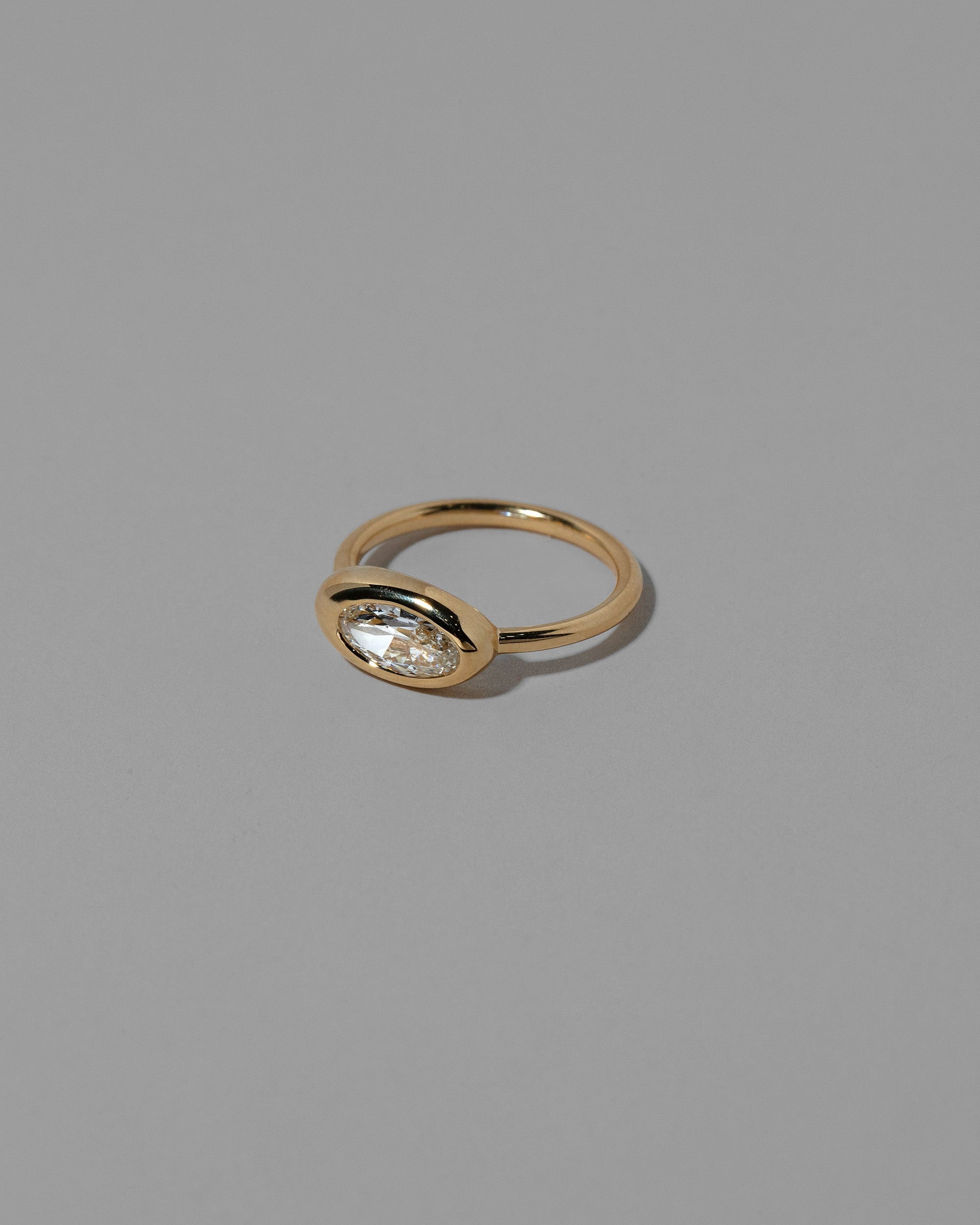 View from the side of the Moval White Diamond Equalize Ring on light color background.