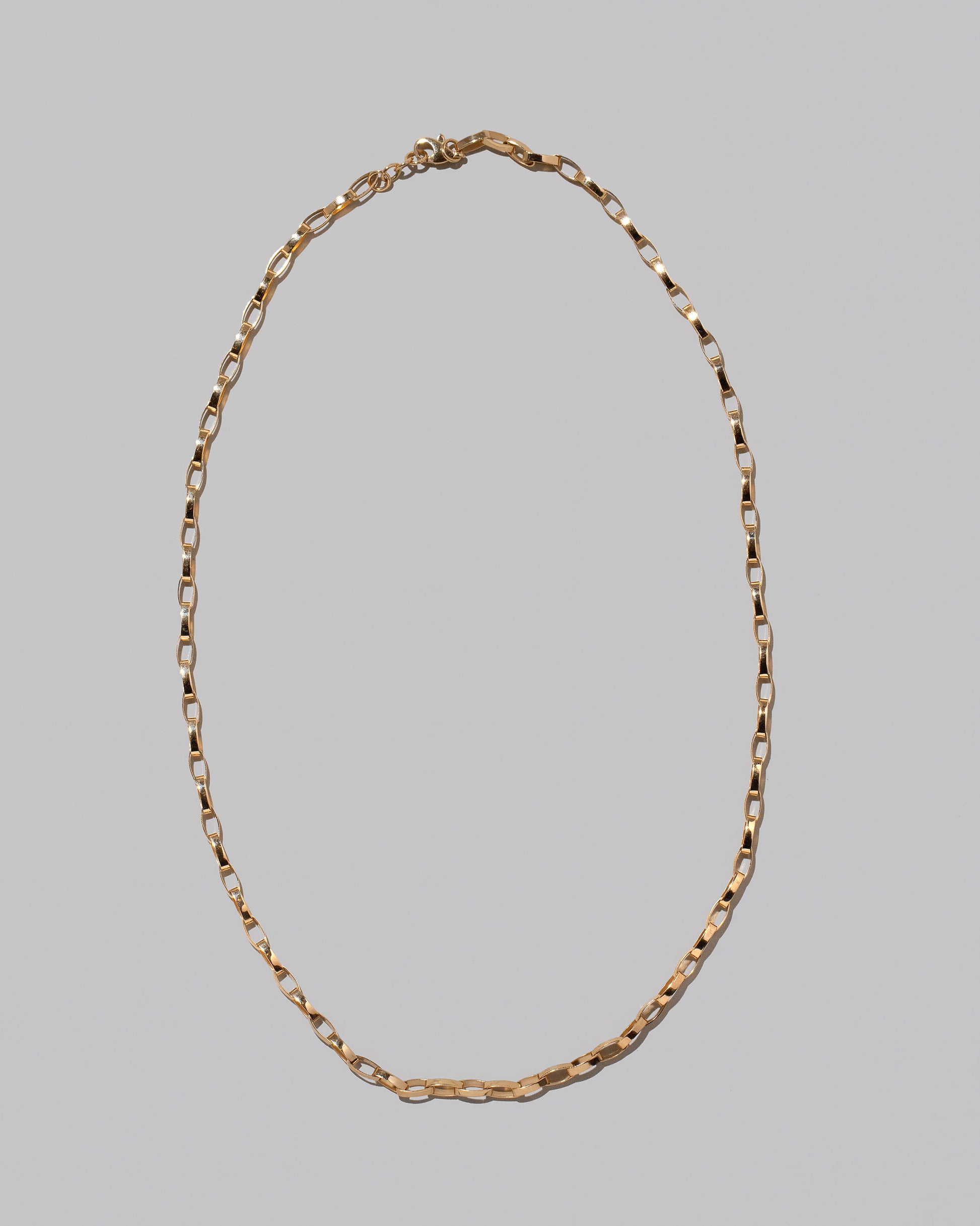 Flat Oval Link Chain Necklace on light color background.