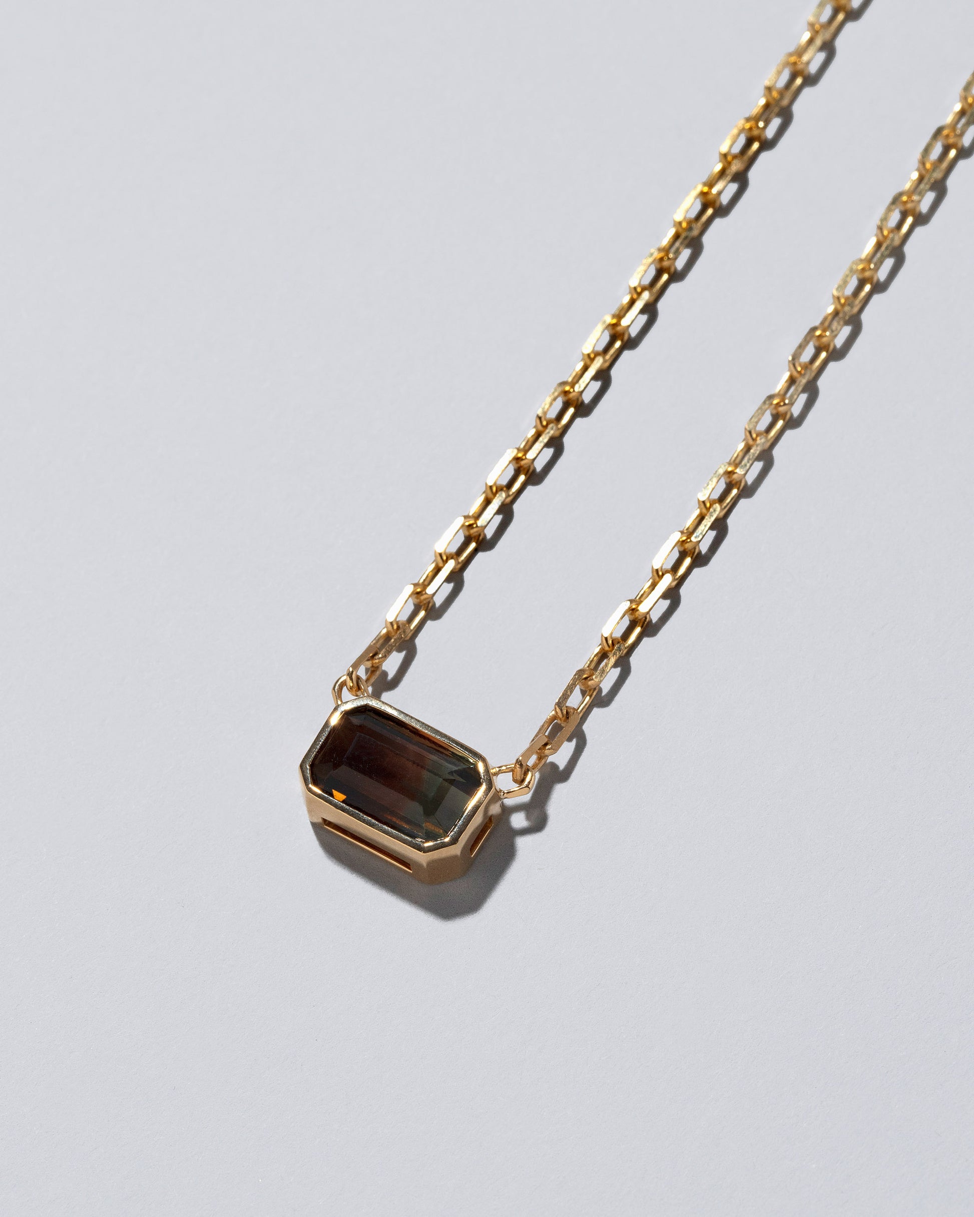 Closeup details of the Field of Love Necklace on light color background.