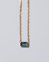 Closeup details of the Attunement Necklace on light color background.