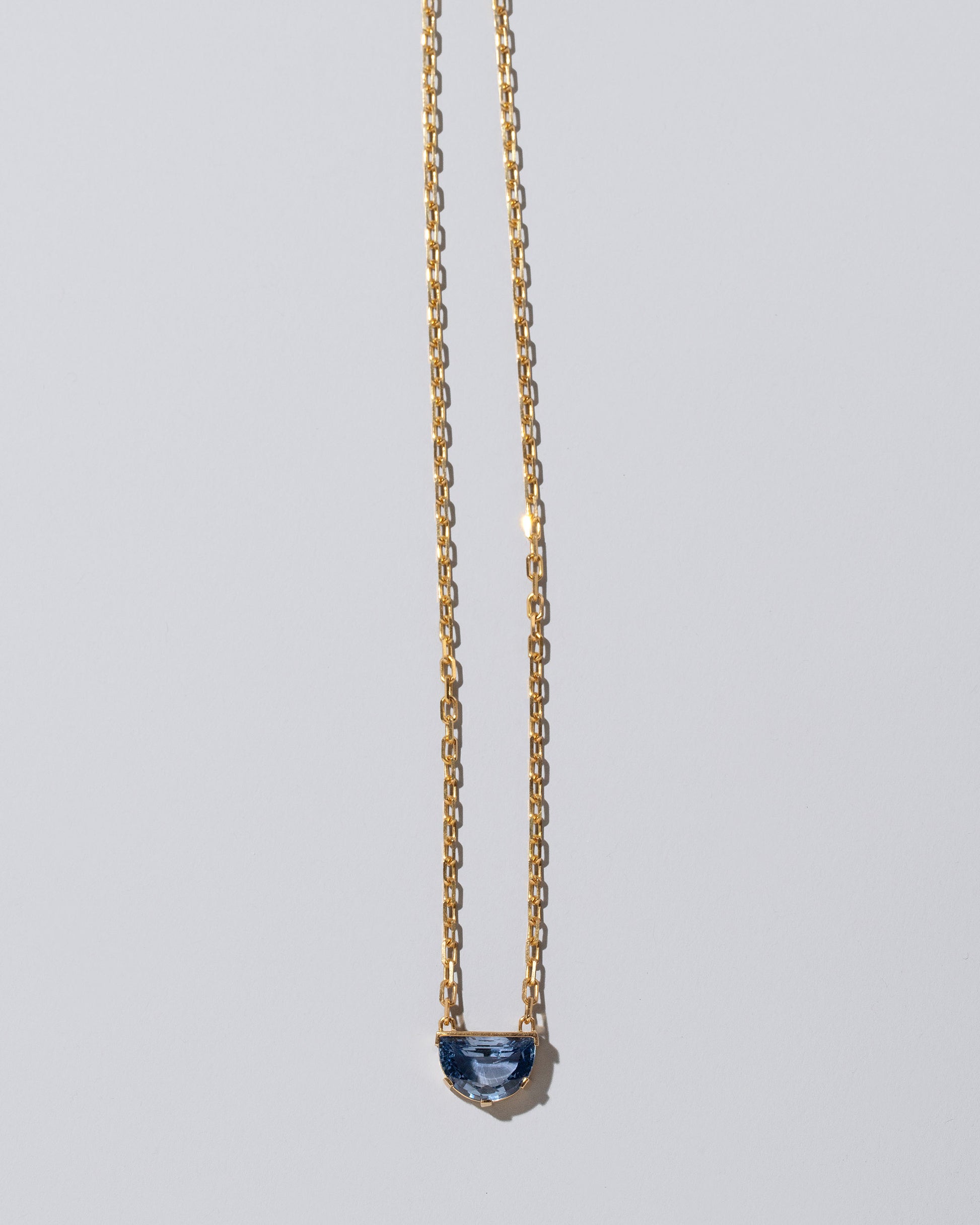 Reverence Necklace on light color background.