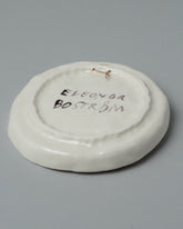 View from the back of the Eleonor Boström Hanging Dog Dish on light color background.