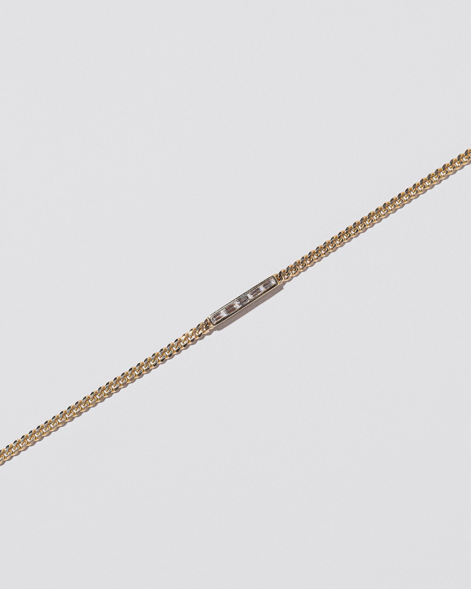 Closeup details of the 2.4mm Diamond Identity Chain Bracelet on light color background.