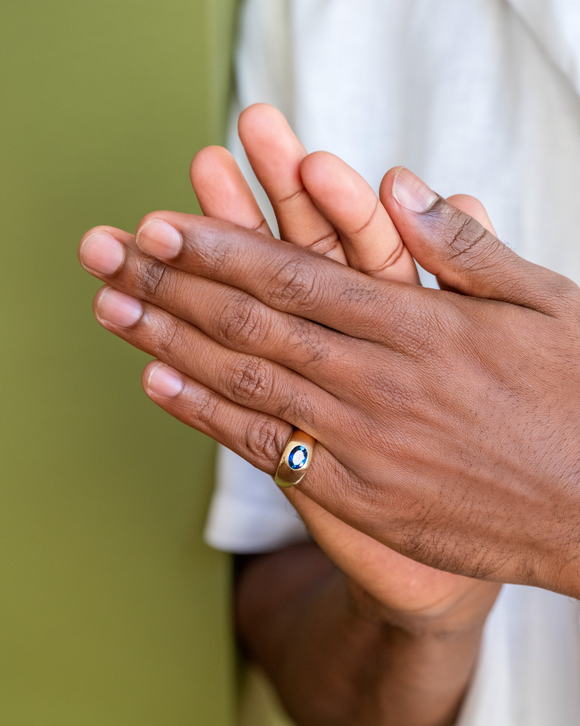 Teal Sapphire Jupiter Ring on male model.