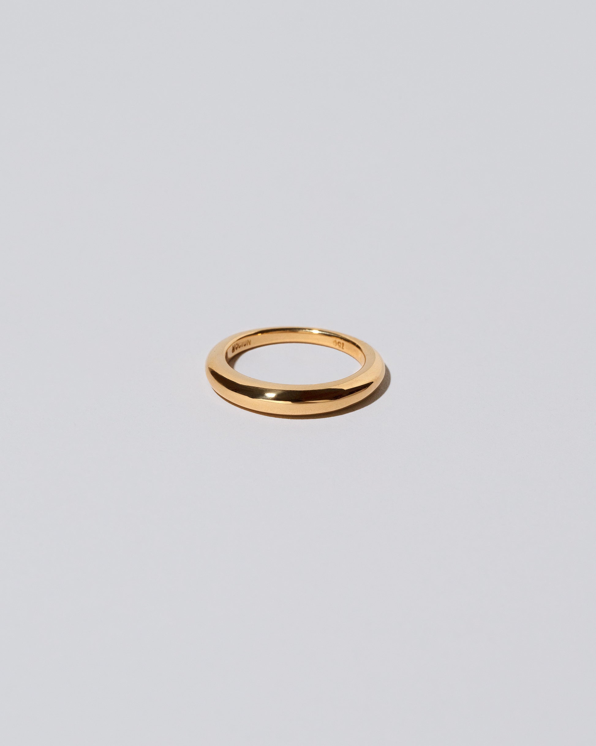 Gold 3.5mm Venus Band on light color background.