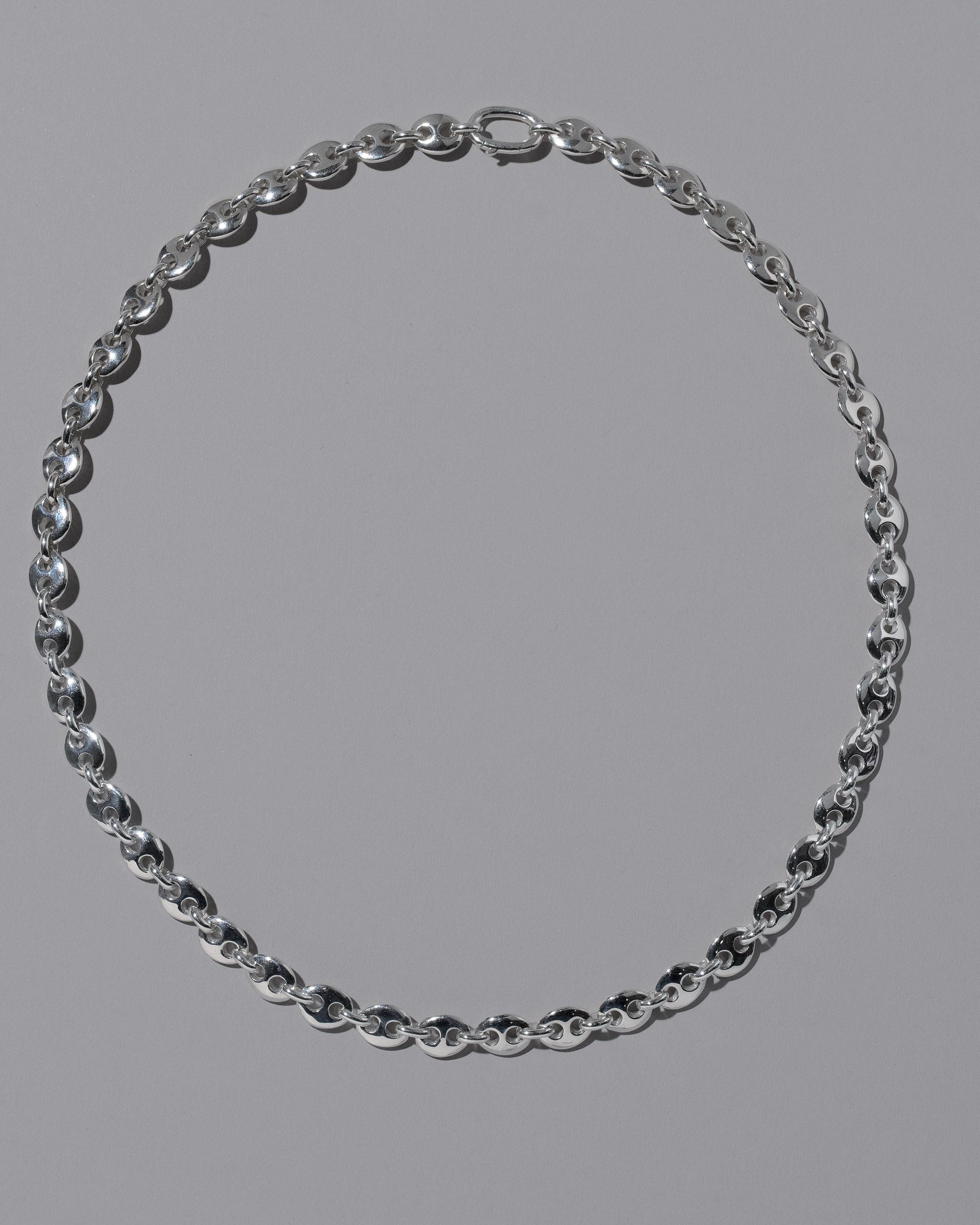 CRZM Sterling Silver Mini Bedrock Necklace on light color background.
