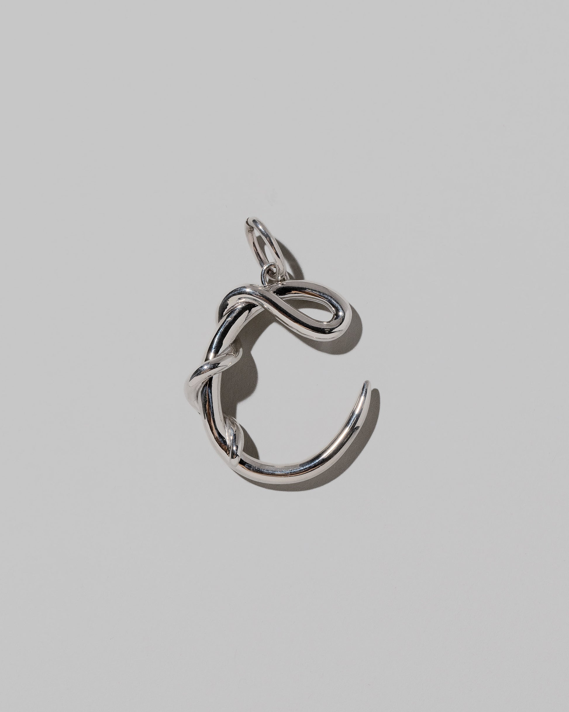 CRZM Large Letter C Charm set in sterling silver on light color background.