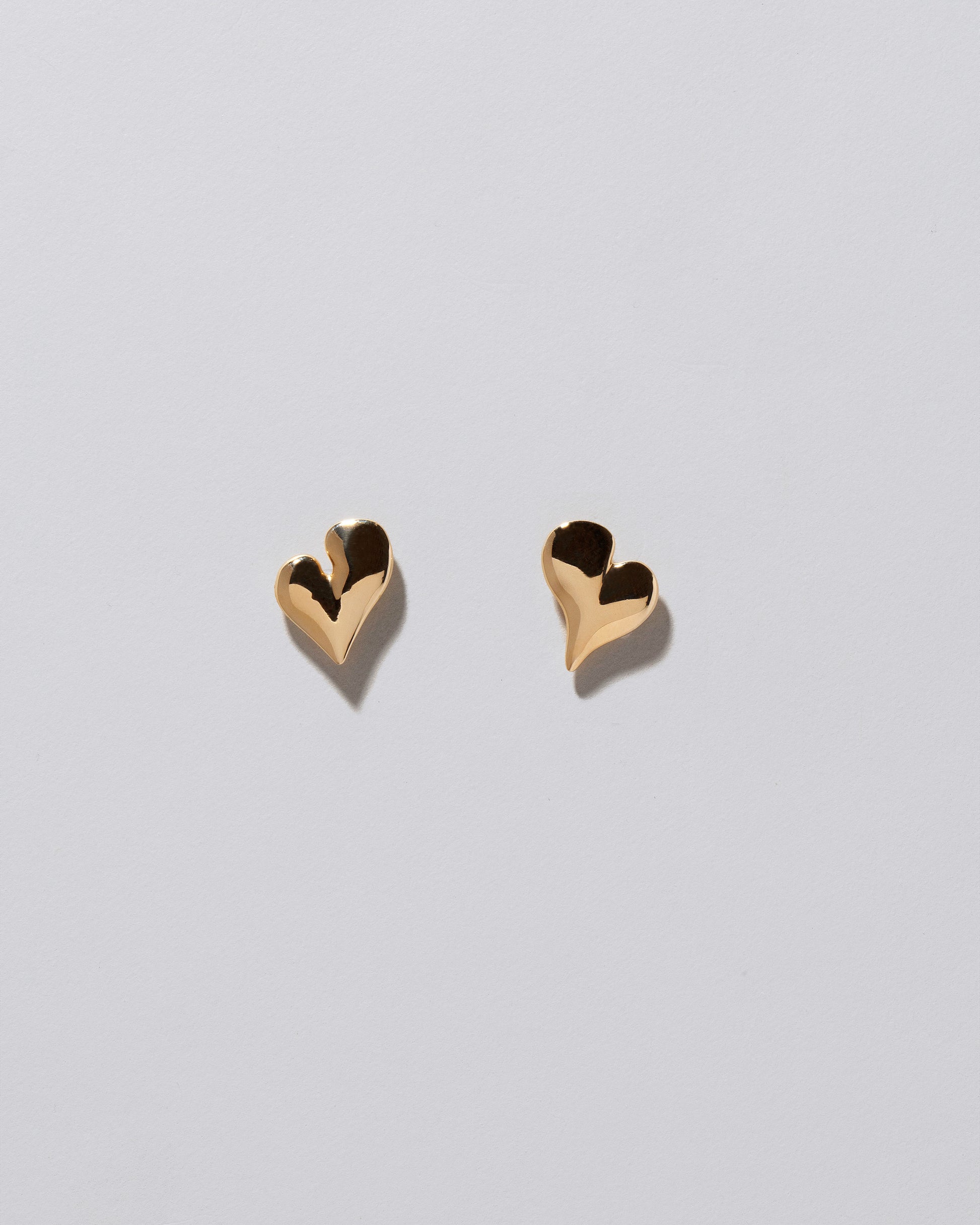 Thousand & One Night Heart Stud Earrings on light color background.