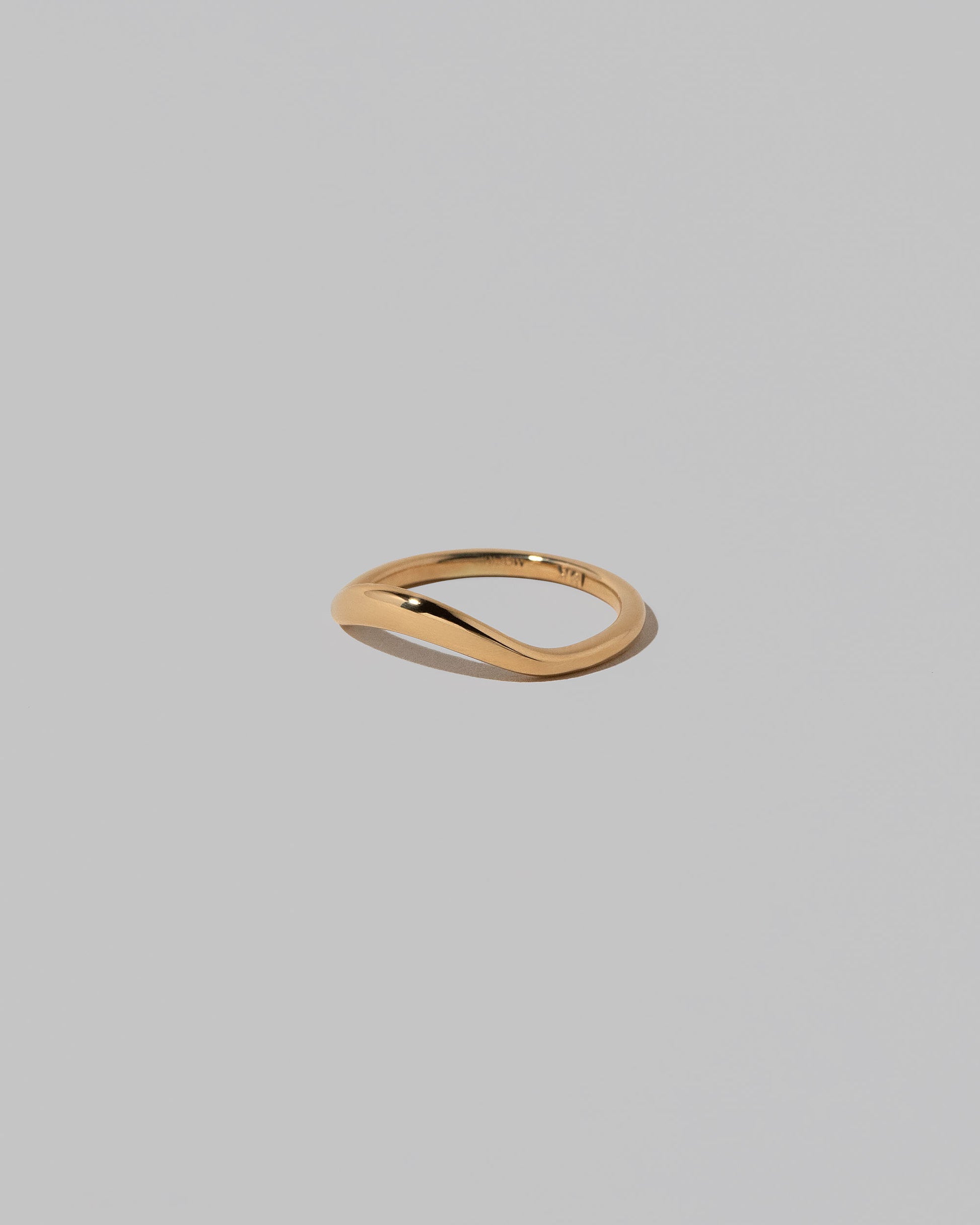 View from the side of the Gold Thin Level Band on light color background.