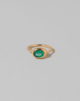 Oval Emerald Equalize Ring on light color background.