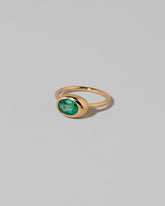 View from the side of the Oval Emerald Equalize Ring on light color background.