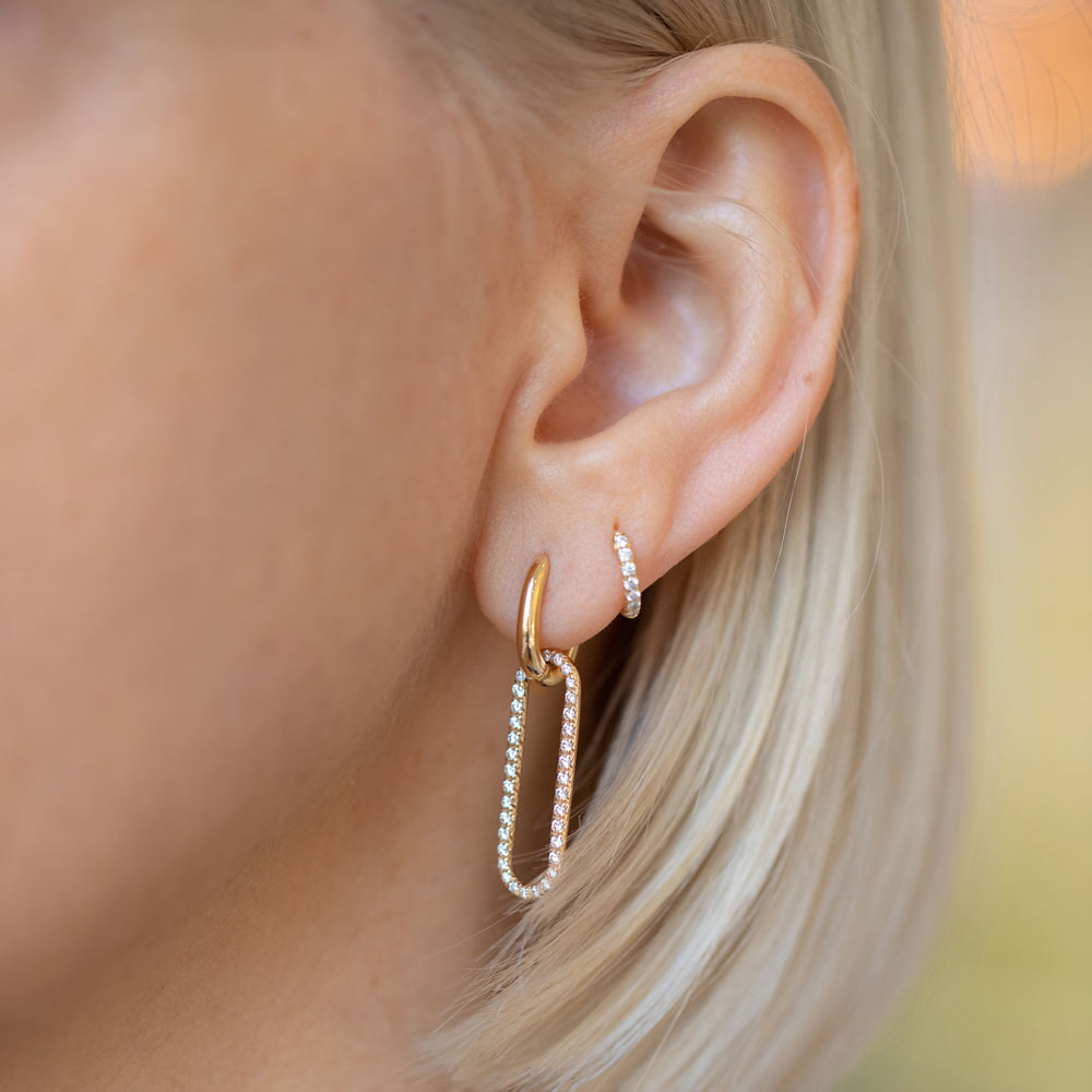 product_details::Pavé Link Huggie Hoop Earrings on model.