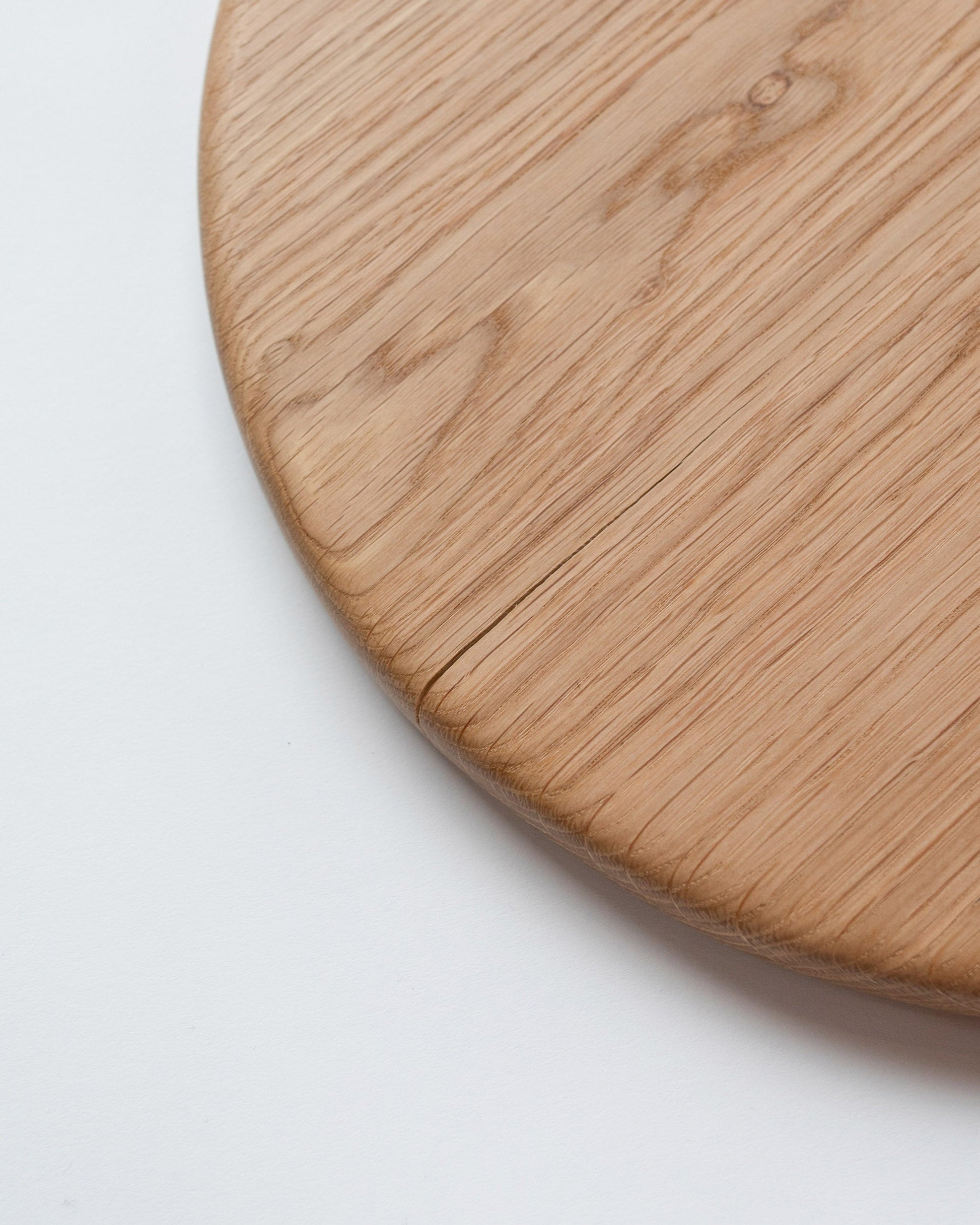 Closeup details of the Lucas Castex No. 10 Hand-Carved Oak Wood Serving Board on light color background.