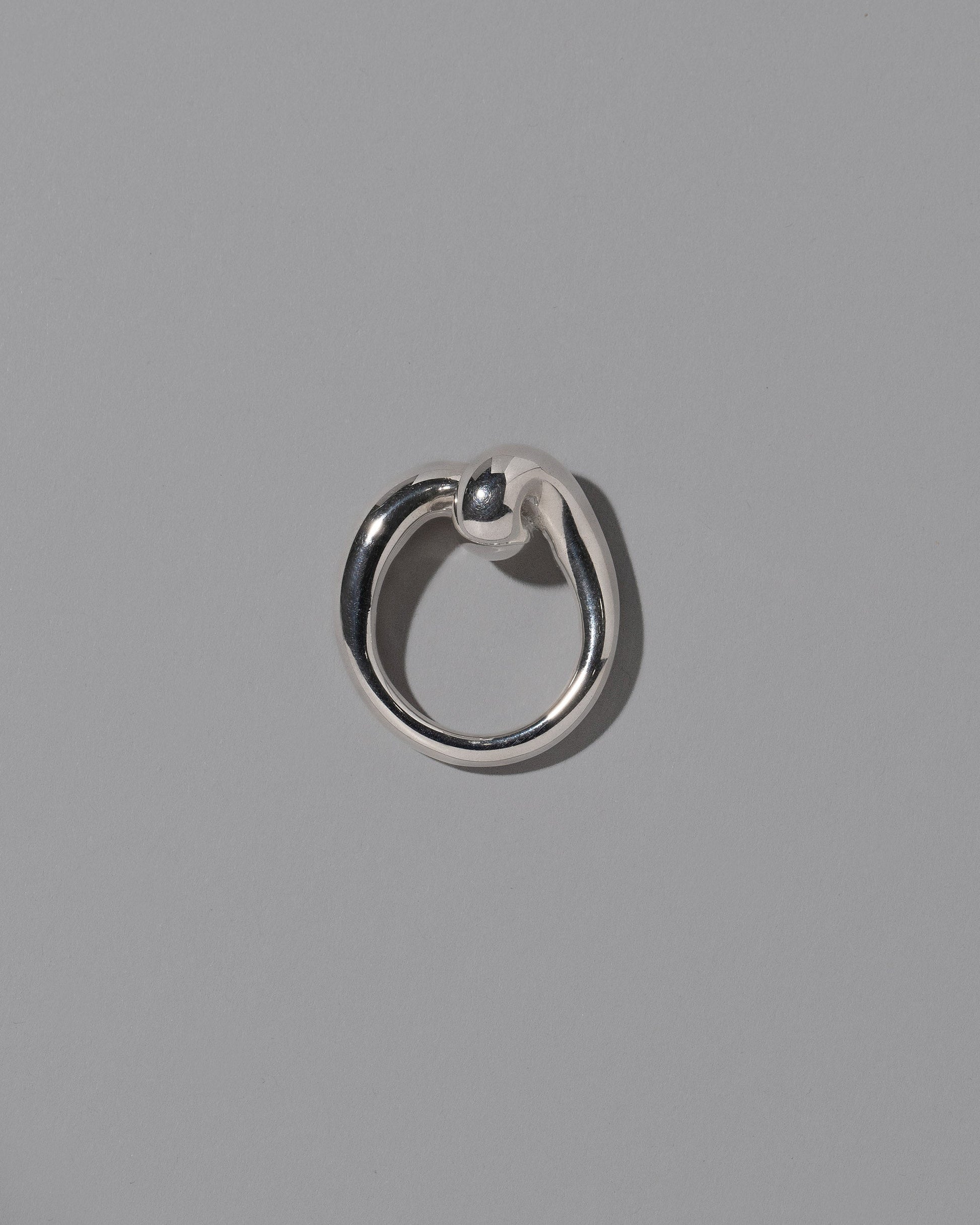 View from the side of the CRZM Sterling Silver Landform Ring on light color background.