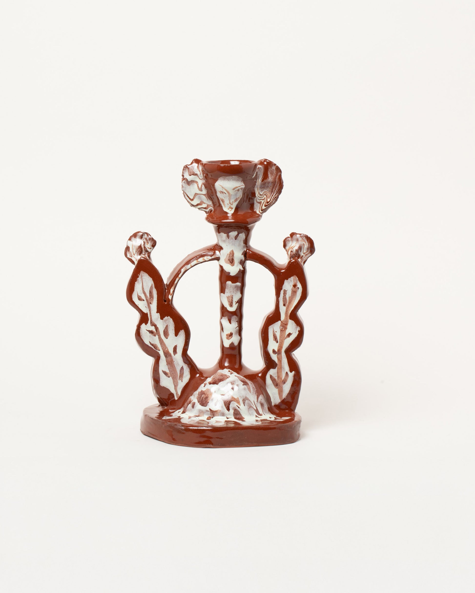 Maggie Boyd Brown Candlestick on light color background.