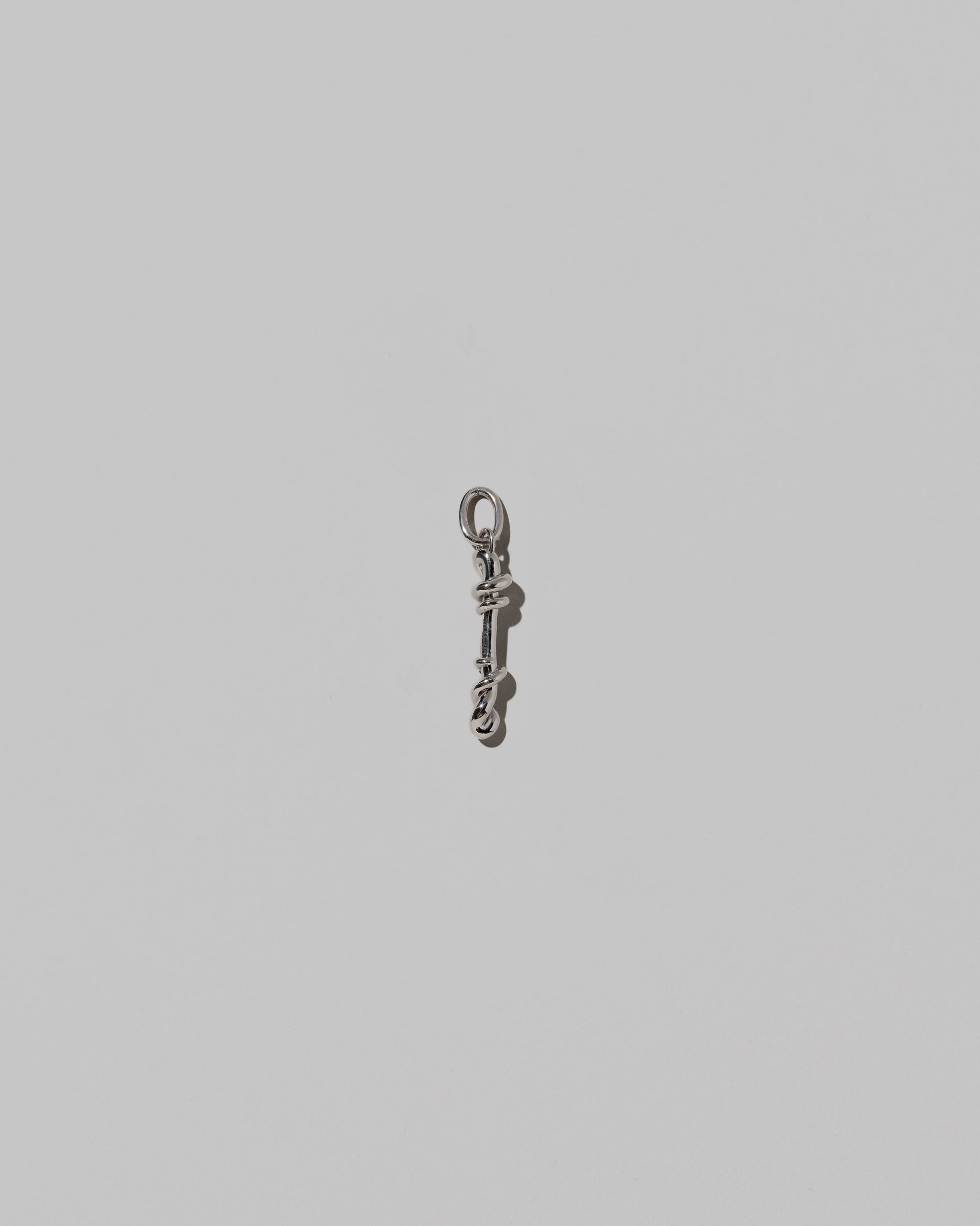 CRZM Medium Letter I Charm set in sterling silver on light color background.