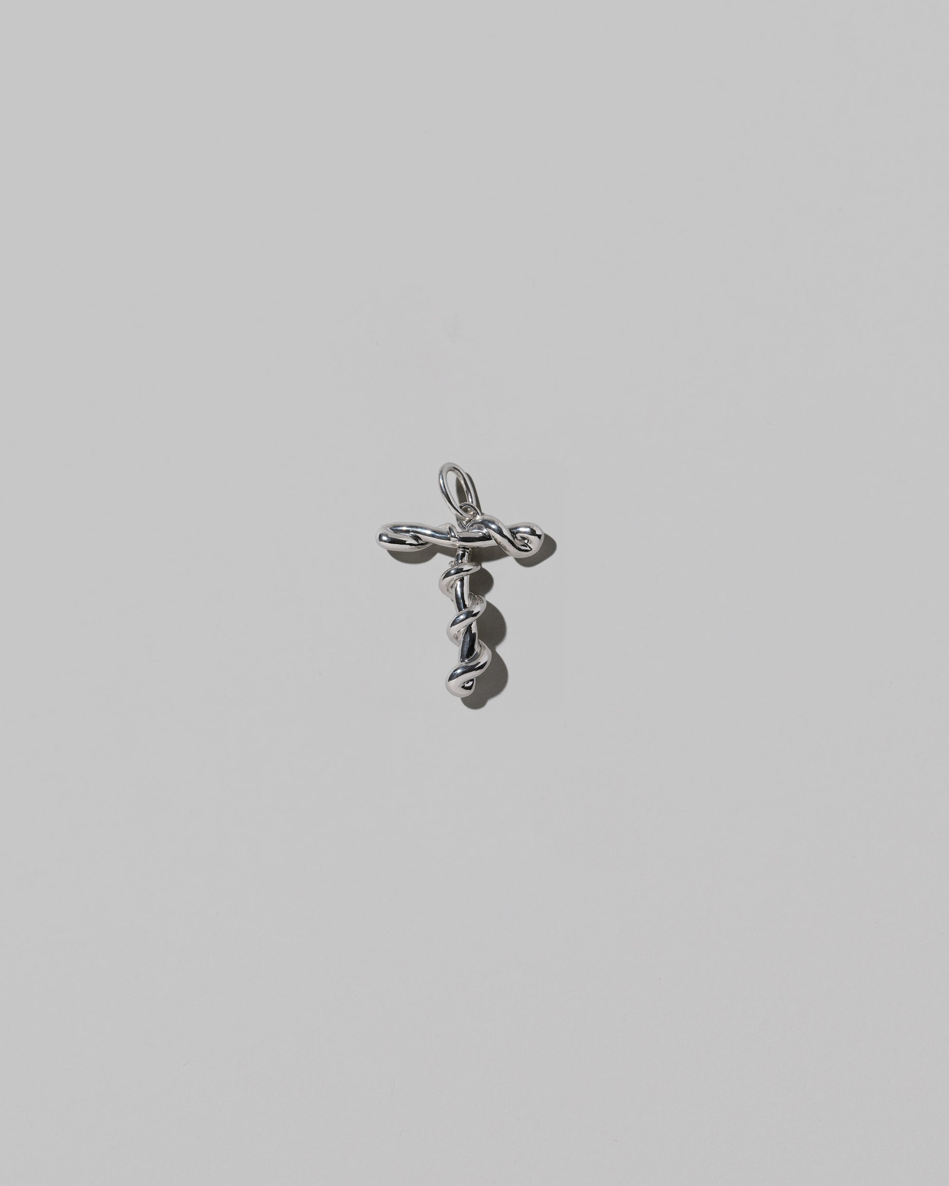 CRZM Medium Letter T Charm set in sterling silver on light color background.