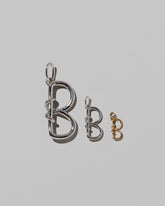 CRZM Large Sterling Silver, Medium Sterling Silver & Mini Letter B Charms set in solid gold on light color background.