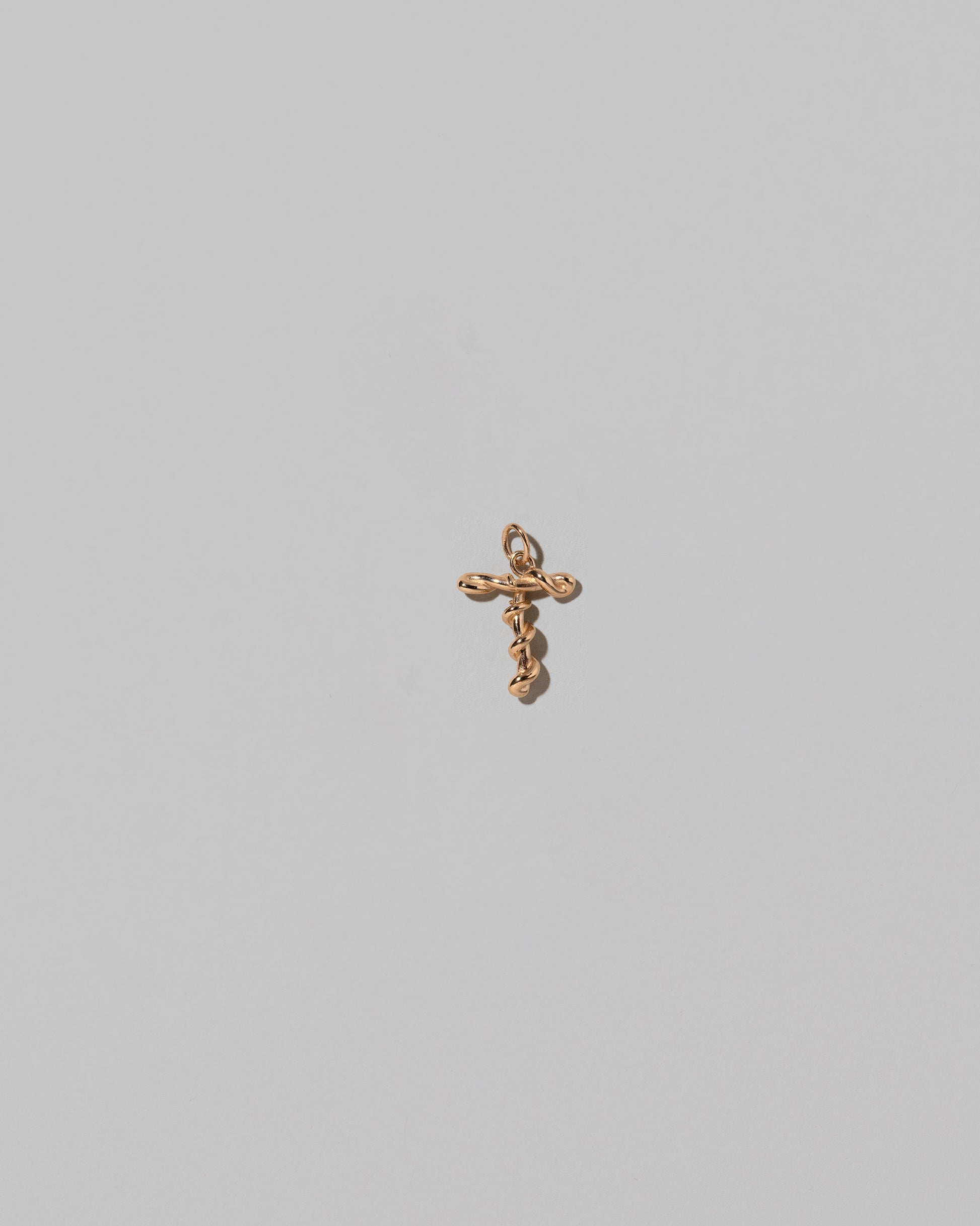 CRZM Mini Letter T set in solid gold on light color background.