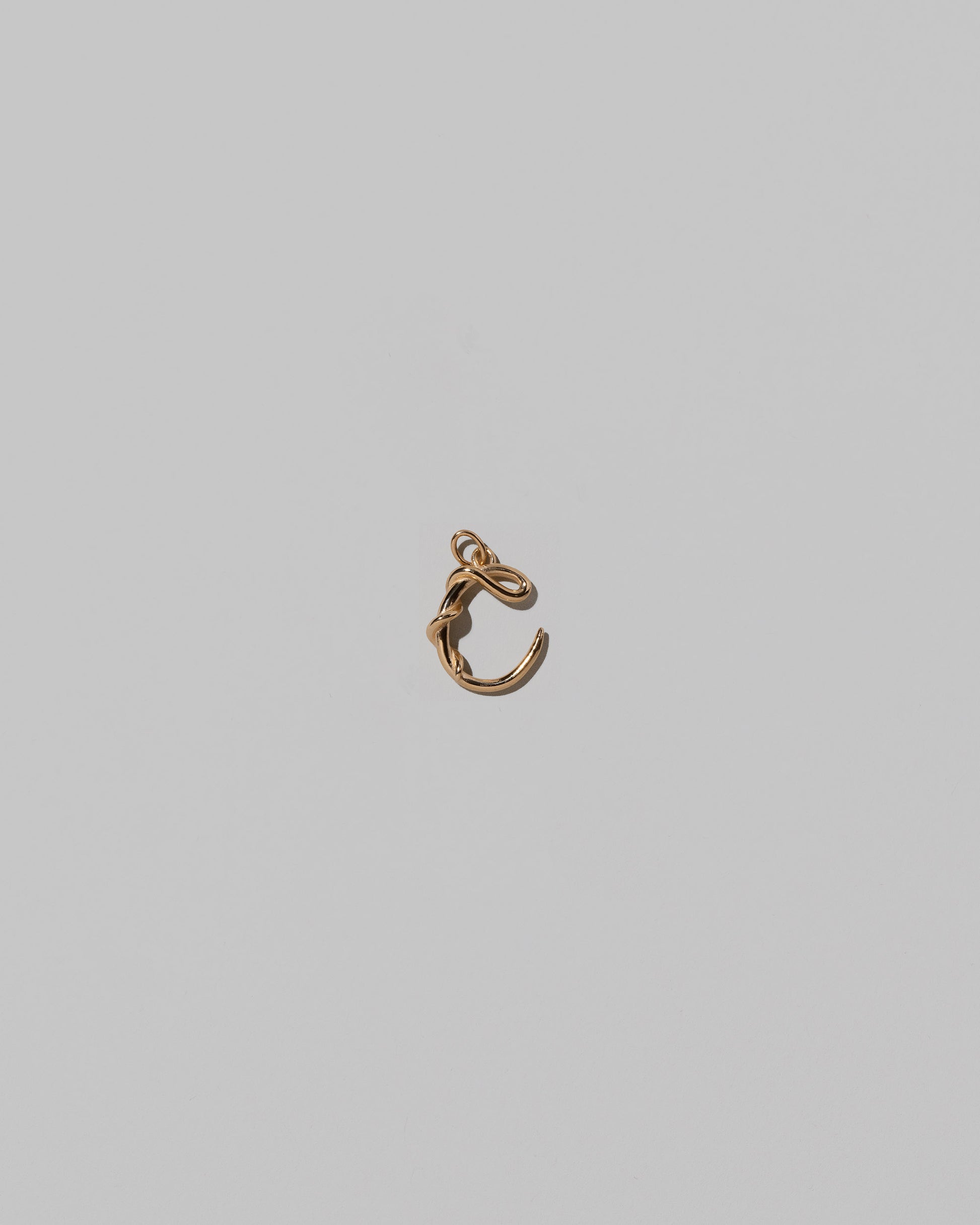 CRZM Mini Letter C set in solid gold on light color background.