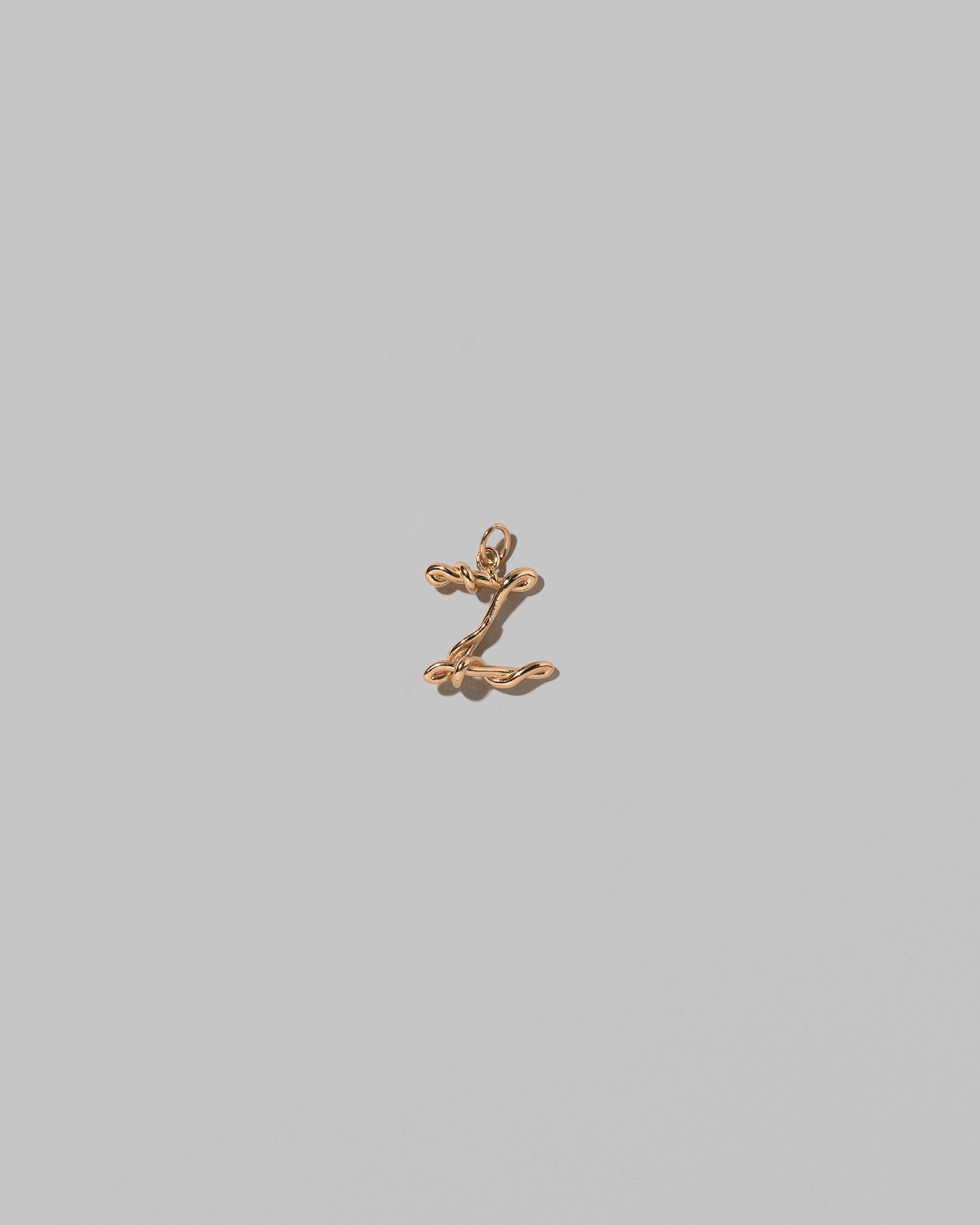 CRZM Mini Letter Z set in solid gold on light color background.