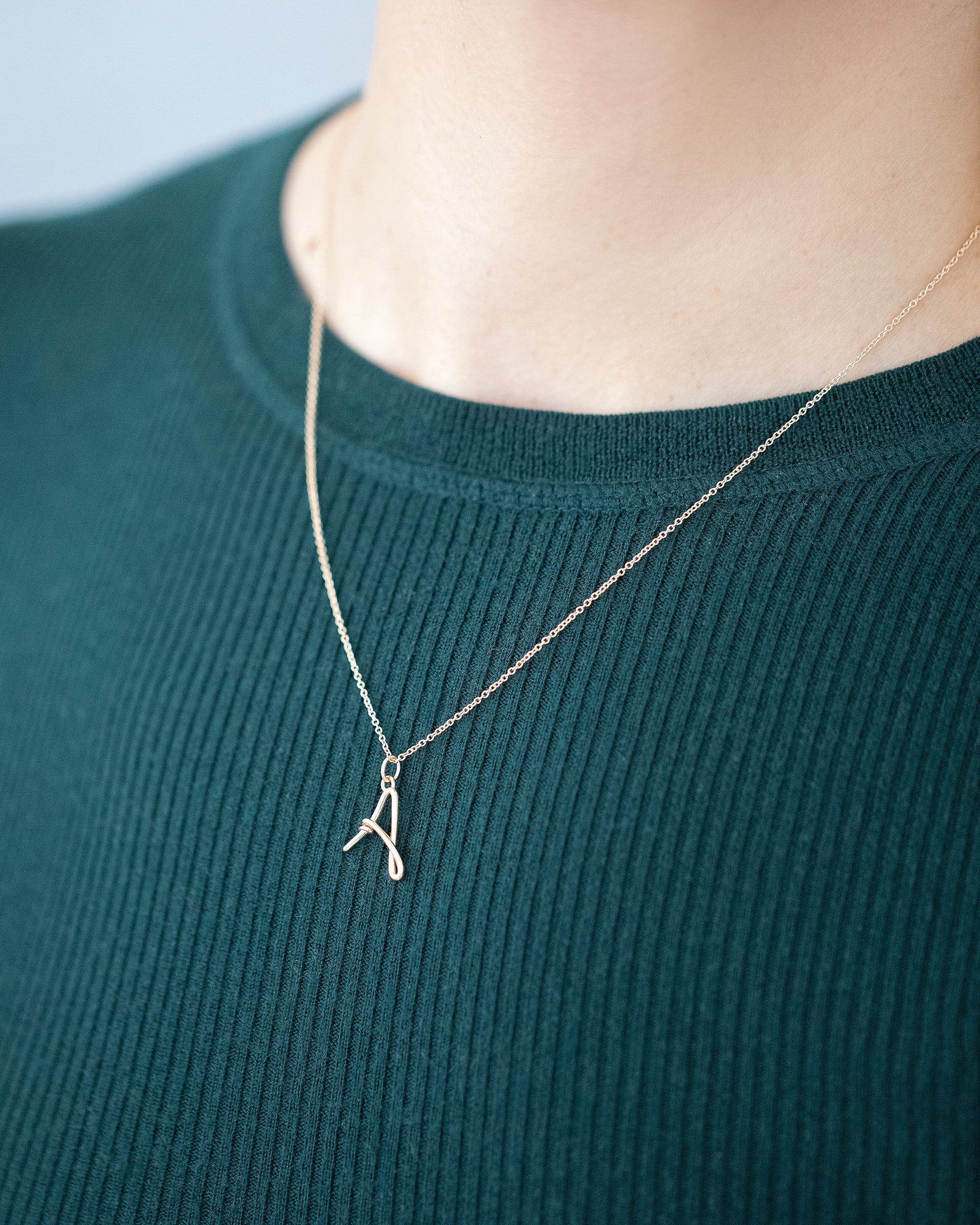 CRZM Mini Letter A and Cable Chain set in solid gold on model.