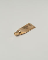 Pearce Objects Cast Bronze Travel-Sized Toothpaste Tube on light color background.