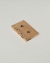 View from the back of the Pearce Objects Cast Bronze Mix Tape on light color background.