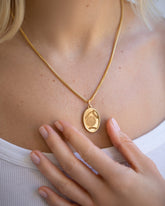 Finished Large Oval Memento Pendant on model, paired with the Mociun 2mm 18" Ritual Chain Necklace. 