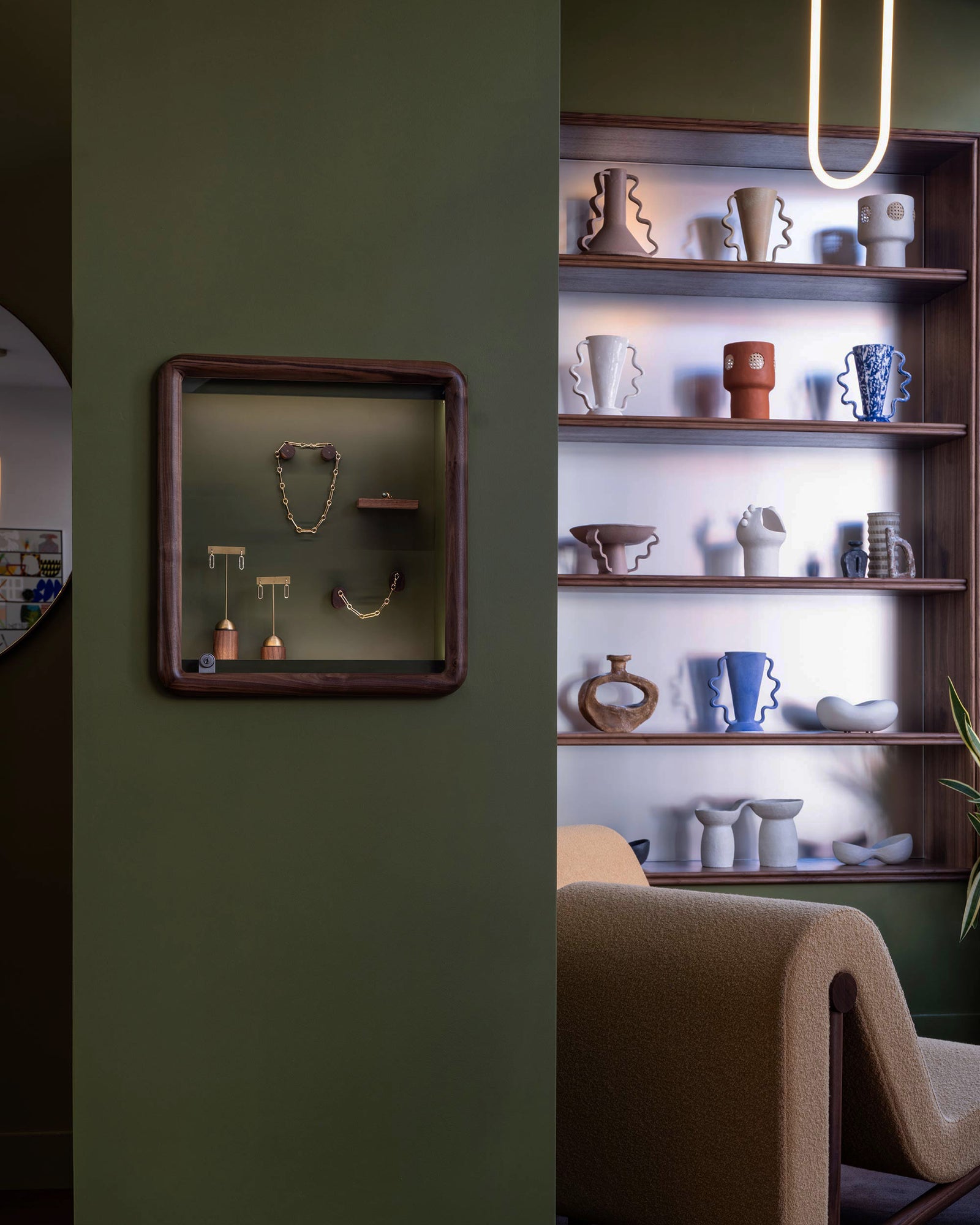 Closeup details of the custom jewelry displays within the Mociun Williamsburg Brooklyn Showroom interior, featuring autumnal colors, warm walnut finishes and  furnishings from Bower Studios.