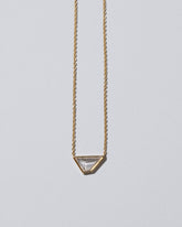 Closeup details of the Amplify Necklace on light color background.