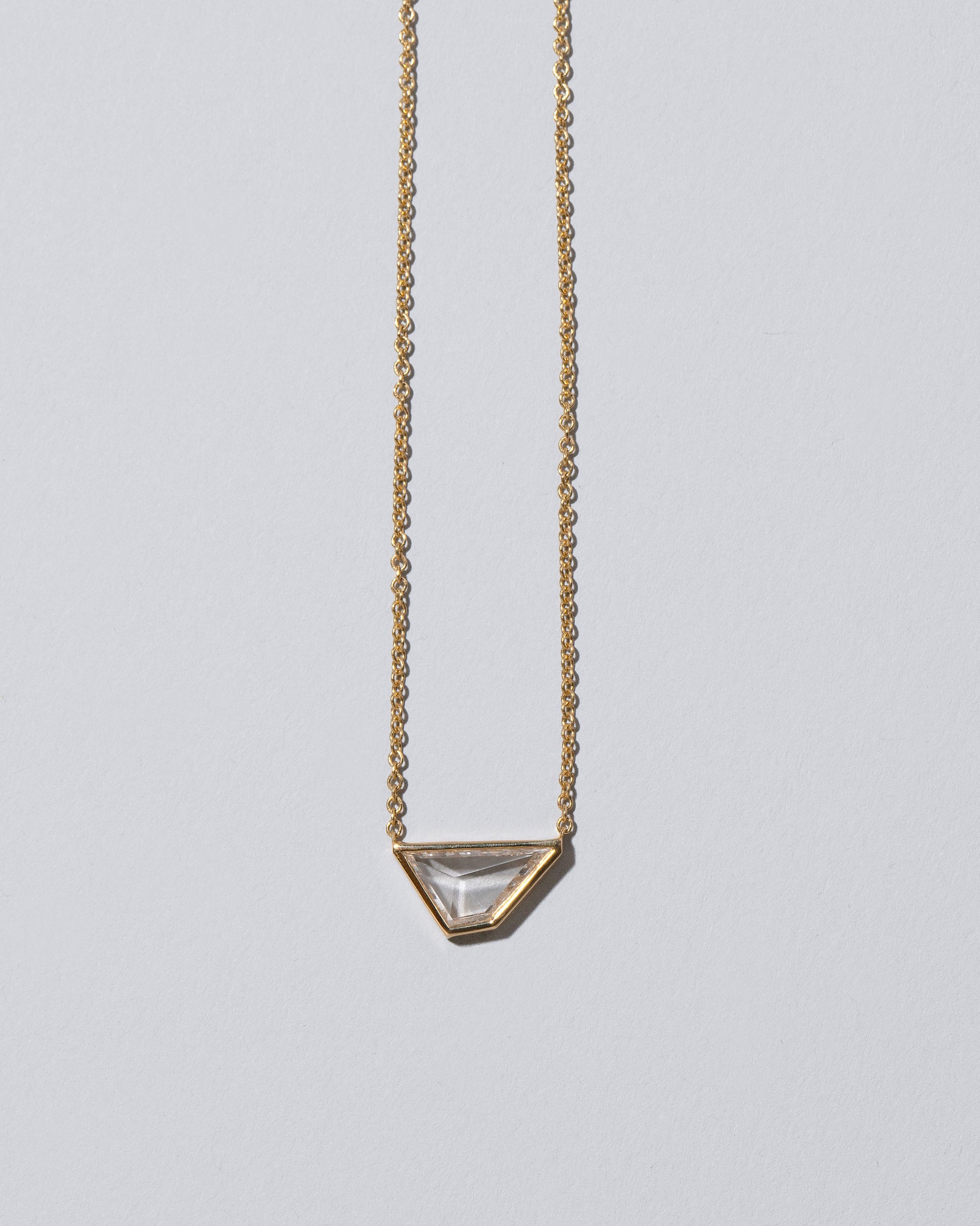 Closeup details of the Amplify Necklace on light color background.