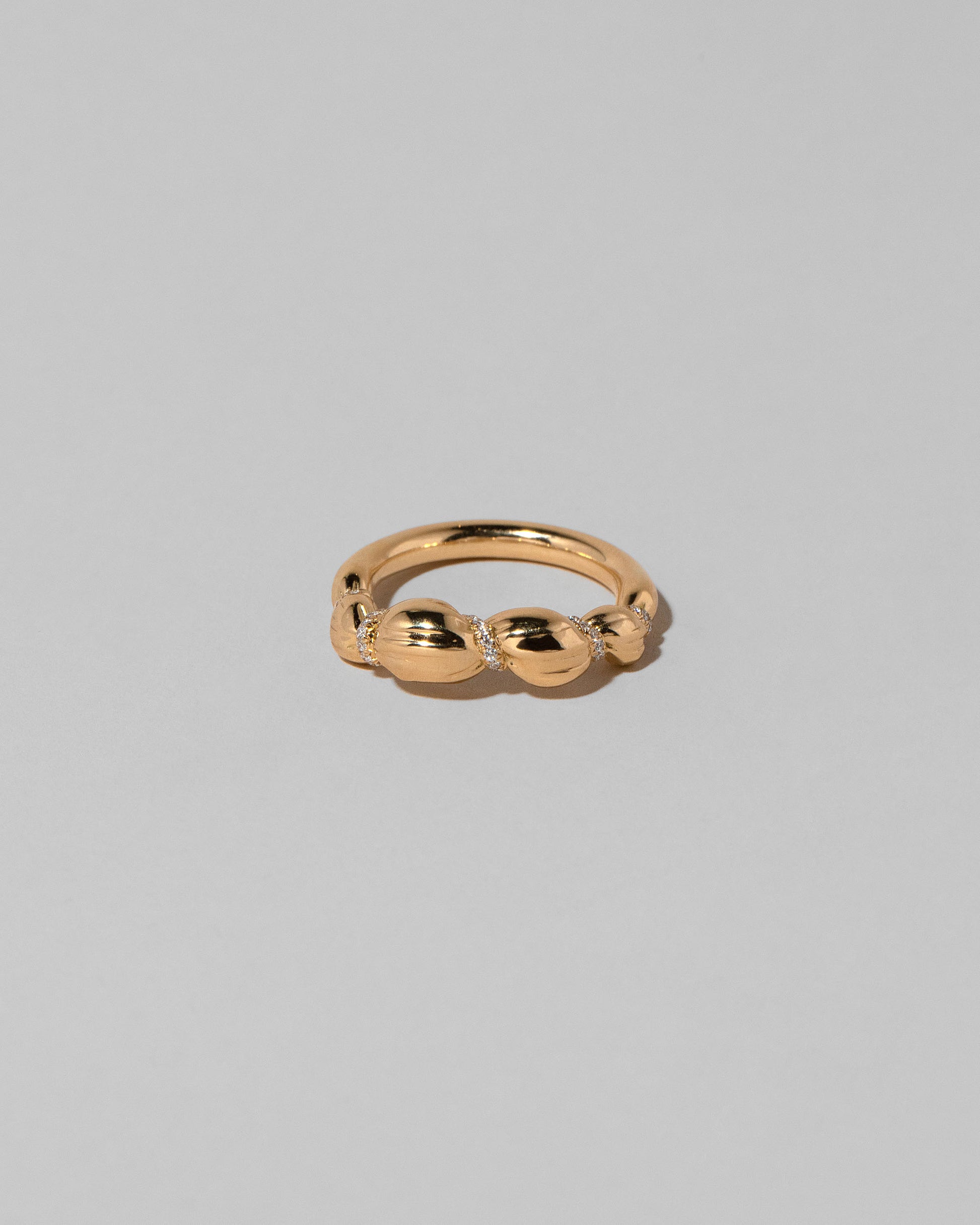 Gold Pavé Bind Band on light color background.