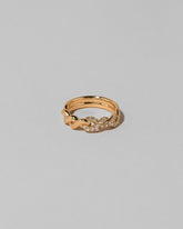 Gold Pavé Twist Band on light color background.