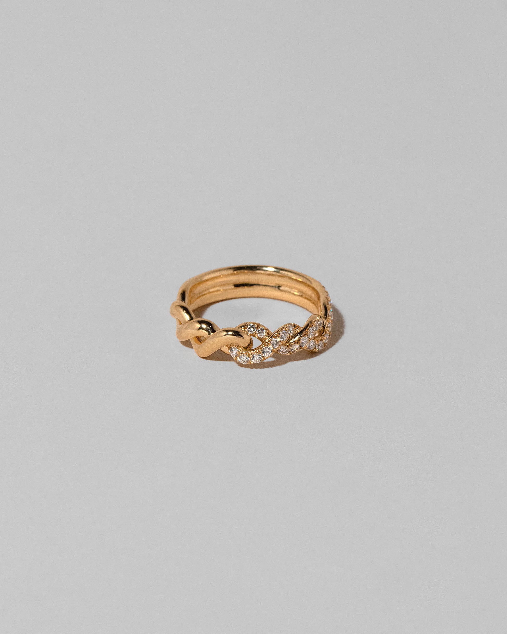 Gold Pavé Twist Band on light color background.