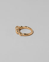 View from the side of the Gold Pavé Bind Band on light color background.