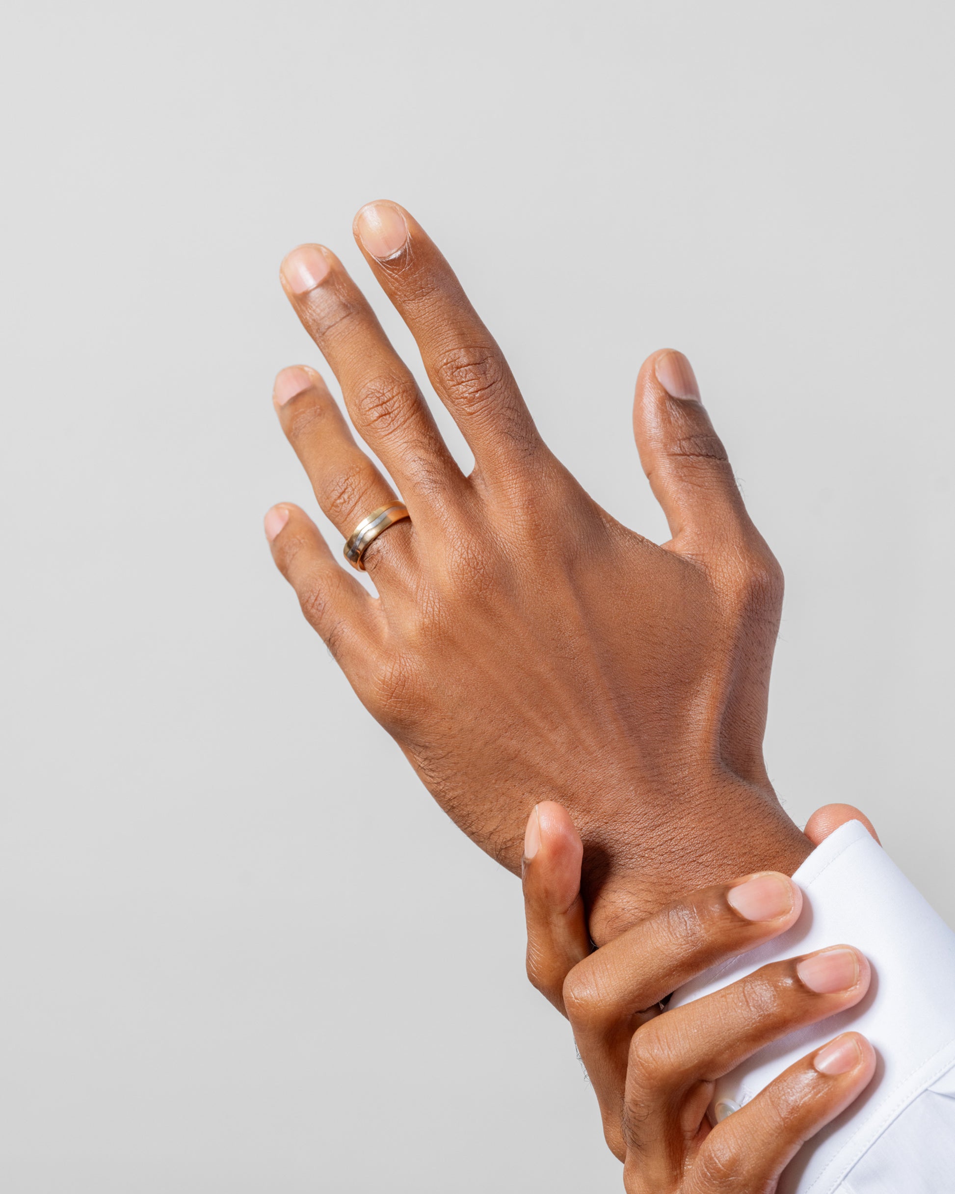 5mm 18K Outside and Platinum Inside Swimming Pool Band on male model.