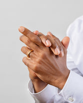 Gold 4.5mm Venus Band on male model.