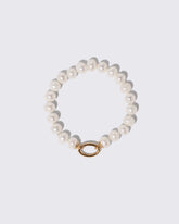 Gold Pearl Openable Link Bracelet on light color background.