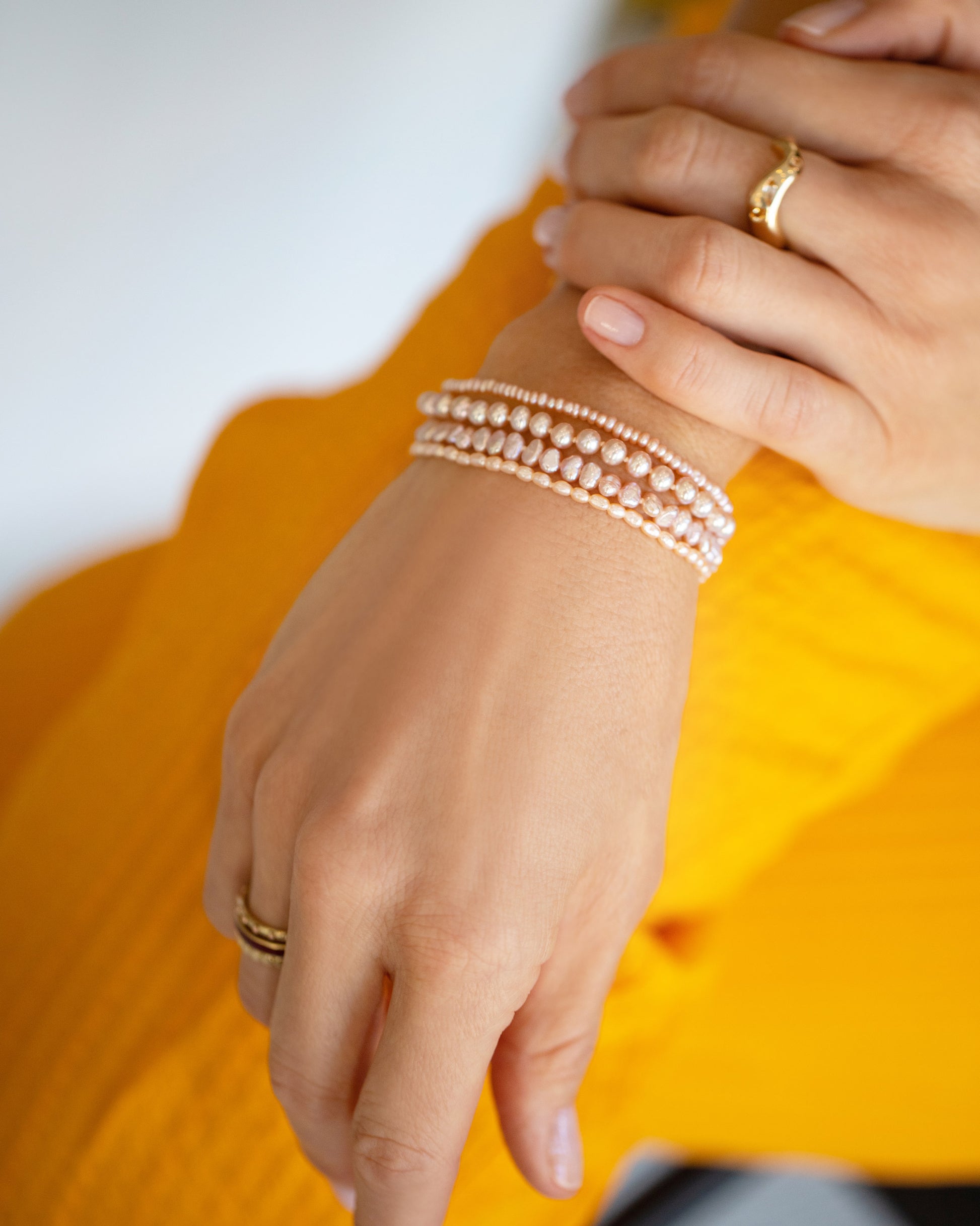 Pink Peony Pebble Seed Pearl Bracelet, Freshwater Pearl Bracelet, Pink Peony Baroque Pearl Bracelet and Pink  Oval Seed Pearl Bracelet on model.